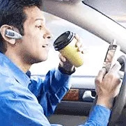 Man talking to phone while drinking coffee